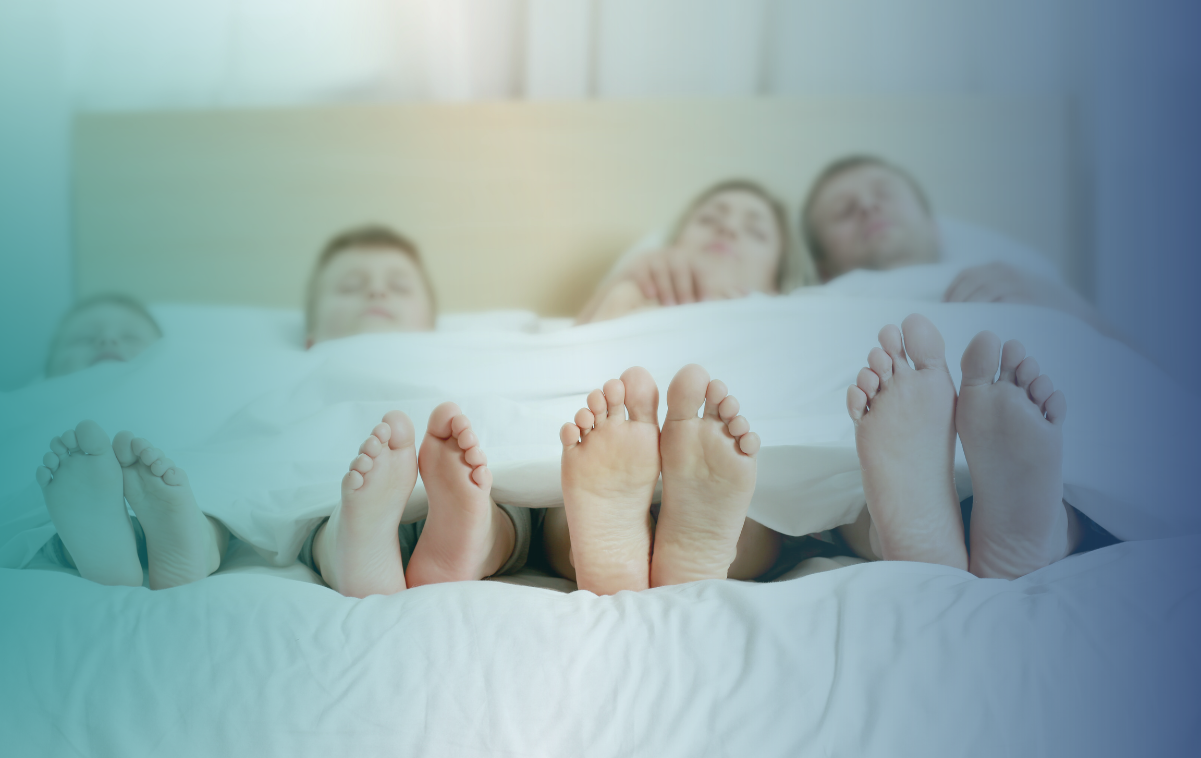 Imagem de uma família dormindo tranquilamente na cama, representando a importância do sono de qualidade para todos.